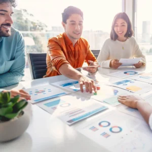 Group of marketers reviewing analytics and digital marketing strategies at a table