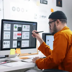 Designer working on branding and design strategy with digital tools.