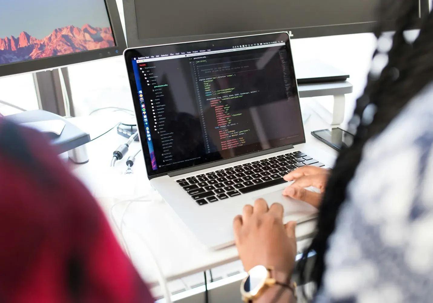 Person coding on a laptop, symbolizing web development services.