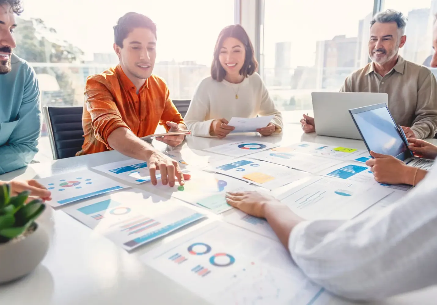 Group of marketers reviewing analytics and digital marketing strategies at a table