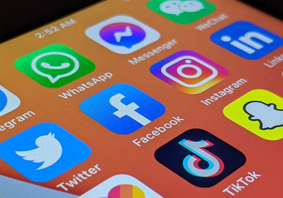 A collection of social media app icons, including WhatsApp, Facebook, Instagram, and TikTok, displayed on a smartphone screen.